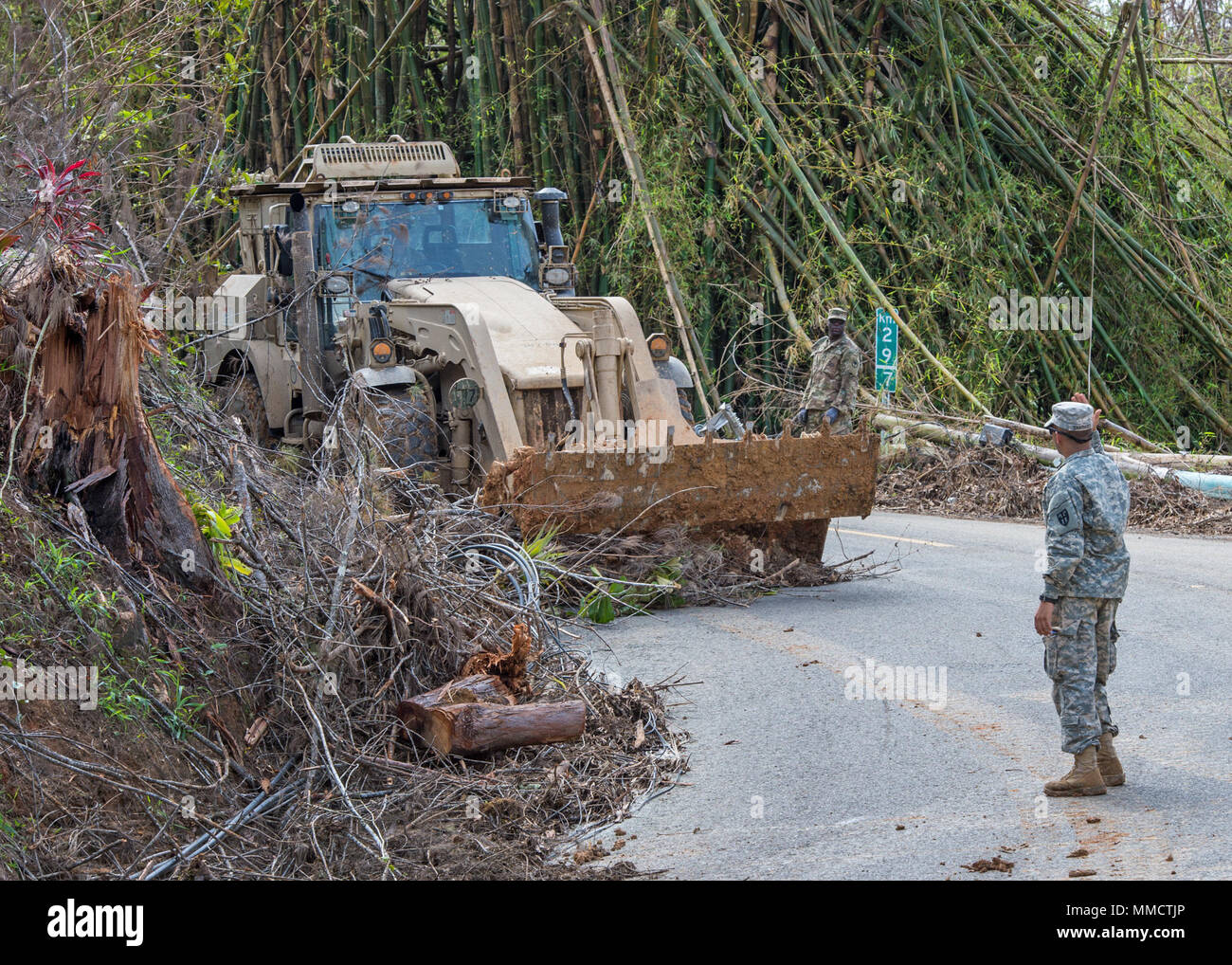 Soldiers from the Puerto Rico Army National Guard and the South Carolina Army National Guard team up to clear debris that blocks roads in the aftermath of Hurricane Maria.  The Soldiers were working in the vicinity of Cayey, Puerto Rico.  (36th Infantry Division photo by Staff Sgt. Mark Scovell) Stock Photo