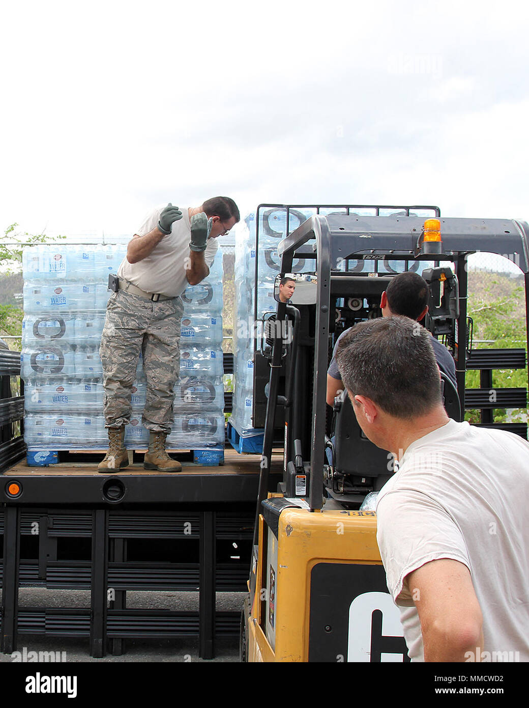 Tech. Sgt. Francisco Calvo directs the loading of a pallet as Airmen