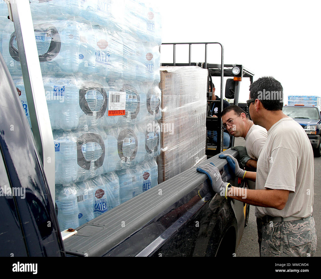 Tech. Sgt. Francisco Calvo directs the loading of a pallet as Airmen