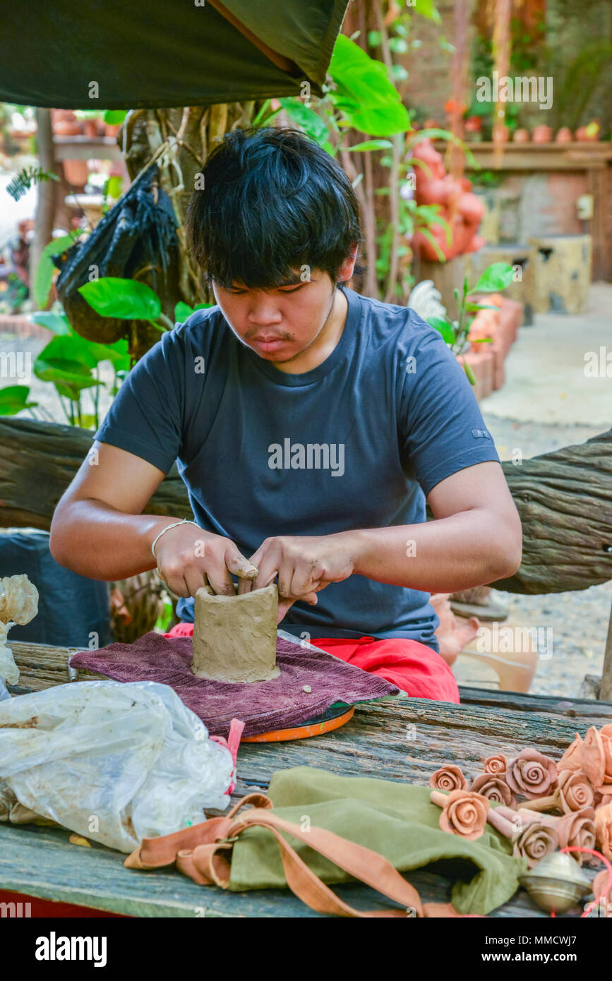 Lopburi, Thailand - July 21, 2013: Craftsman making pottery of dolls and sculpture of animals from clay in the workshop in Lopburi, Thailand Stock Photo