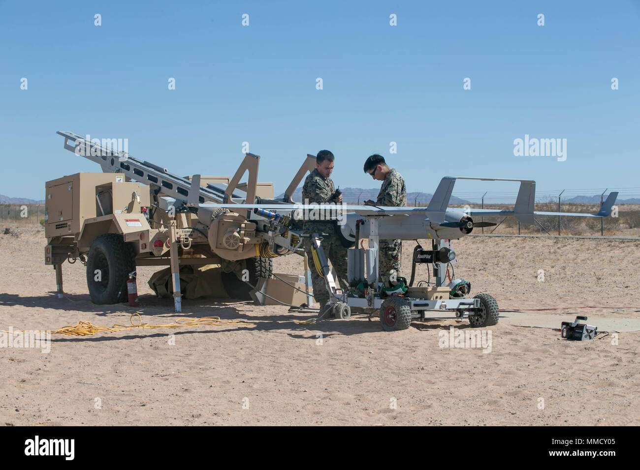 U.S. Marines with Marine Unmanned Aerial Vehicle Squadron One prepare to launch a RQ-21 Blackjack UAS during Weapons and Tactics Instructors Course (WTI) 1-18 at Yuma, Ariz., on Oct. 13, 2017. WTI is a seven week training event hosted by Marine Aviation and Weapons Tactics Squadron One (MAWTS-1) cadre which emphasizes operational integration of the six functions of Marine Corps Aviation in support of a Marine Air Ground Task Force. MAWTS-1 provides standardized advanced tactical training and certification of unit instructor qualifications to support Marine Aviation Training and Readiness and a Stock Photo