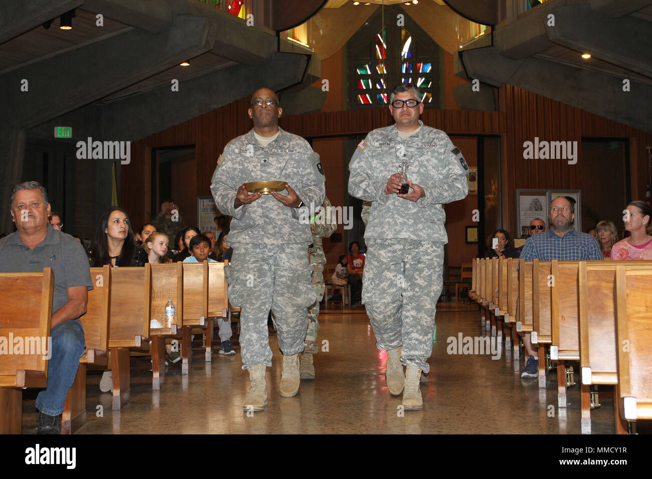 Spc. Donald Logan, left, and Spc. Jesus Flores of the California Army National Guard bring the communion offering forward during an Oct. 15 special Catholic mass to honor CalGuard Soldiers who are helping law enforcement deal with the Northern California wildfires. Representatives from the 185th Military Police Battalion, 49th Military Police Brigade, attended the service at Saint John the Baptist Church, Napa, California. (Army National Guard photo by Staff Sgt. Eddie Siguenza) Stock Photo