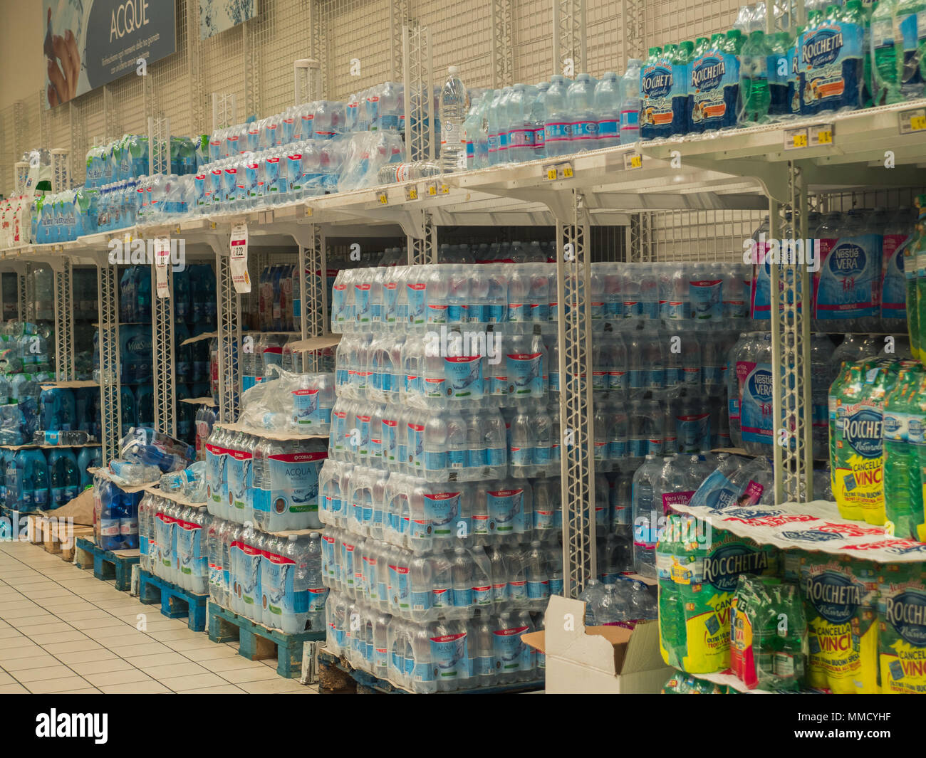 Rimini, Italy, March 21, 2018 shelves of plastic water bottles to shopping center , symbols of huge daily  use of plastic. Stock Photo