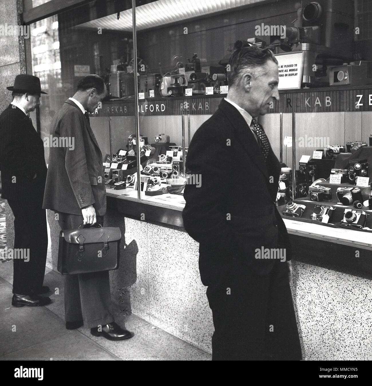 1960s, London, businessmen looking at the large range of photographic