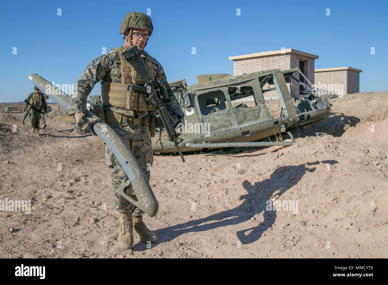 A U.S. Marine with Marine Wing Support Squadron 371 (MWSS 371) participates in a simulated aircraft salvage exercise during Weapons and Tactics Instructors Course (WTI) 1-18 at Yuma, Ariz., on Oct. 14, 2017. WTI is a seven week training event hosted by Marine Aviation and Weapons Tactics Squadron One (MAWTS-1) cadre which emphasizes operational integration of the six functions of Marine Corps Aviation in support of a Marine Air Ground Task Force. MAWTS-1 provides standardized advanced tactical training and certification of unit instructor qualifications to support Marine Aviation Training and  Stock Photo