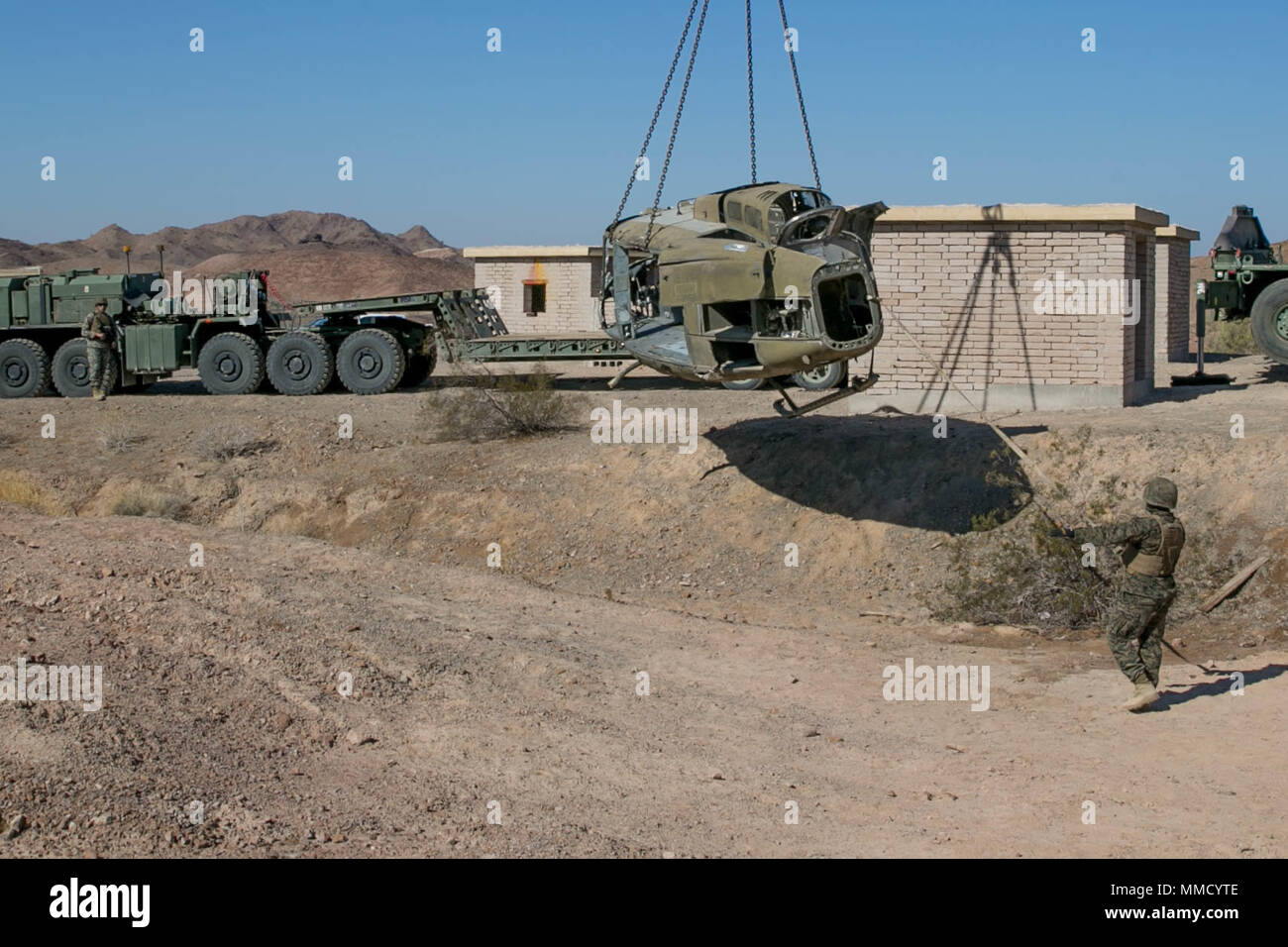 U.S. Marines with Marine Wing Support Squadron 371 (MWSS 371) participate in a simulated aircraft salvage exercise during Weapons and Tactics Instructors Course (WTI) 1-18 at Yuma, Ariz., on Oct. 14, 2017. WTI is a seven week training event hosted by Marine Aviation and Weapons Tactics Squadron One (MAWTS-1) cadre which emphasizes operational integration of the six functions of Marine Corps Aviation in support of a Marine Air Ground Task Force. MAWTS-1 provides standardized advanced tactical training and certification of unit instructor qualifications to support Marine Aviation Training and Re Stock Photo