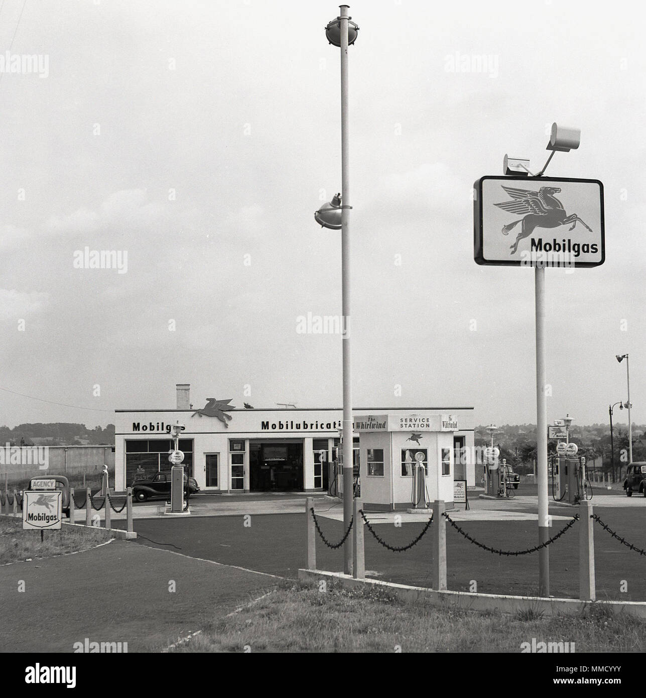 Exterior view of a Mobilgas service station at Osterley Park, 1950s, 'The Whirlwind' on A4 near London, England, UK. These petrol stations were proper 'service stations', as attendants would be on hand to refuel your car,  clean your windscreen - as seen by the hut by the fuel pumps - and provide vehicle maintenance. Stock Photo