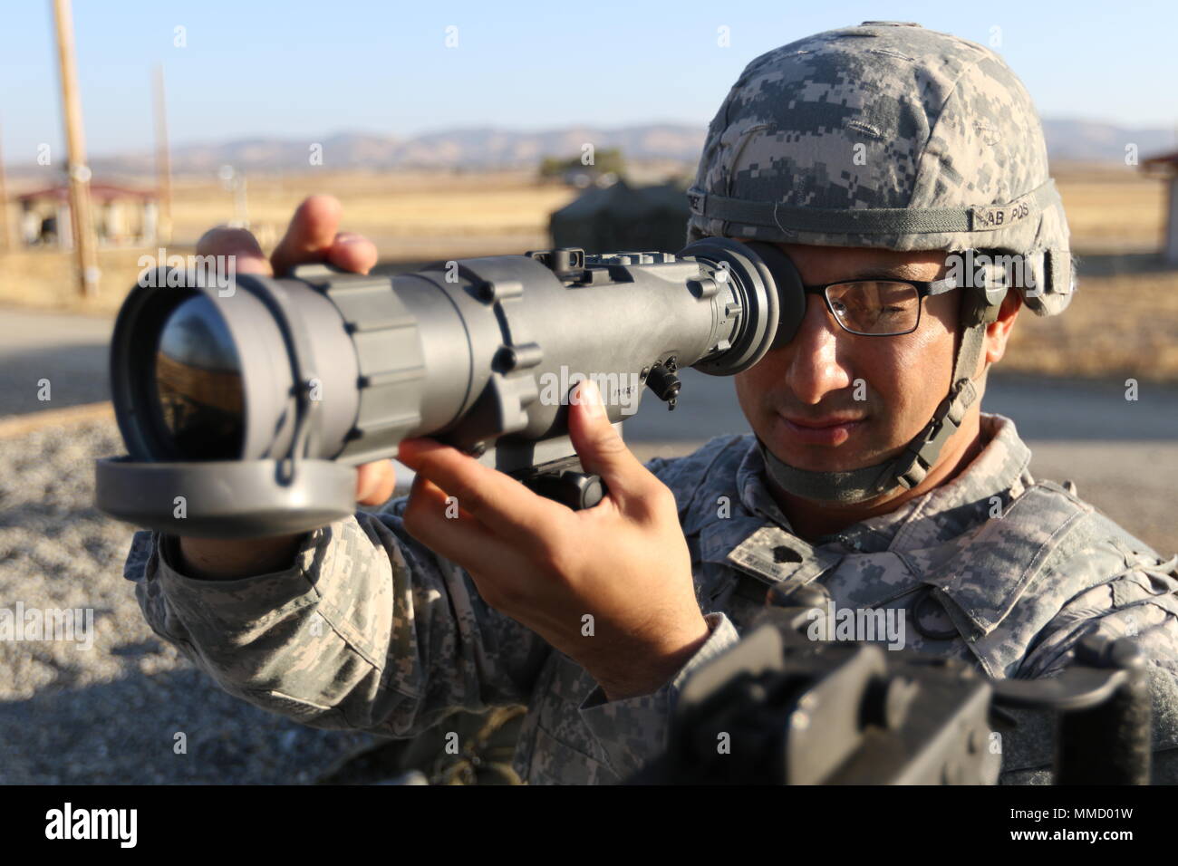 U.S. Army Reserve Spc. Justin Martinez, paralegal specialist, 382nd Combat Sustainment Support Battalion, views the range through a AN/PAS-13 Thermal Weapon Sight in preparation for sending the first rounds downrange for weapons qualification during Operation Cold Steel II, hosted by the 79th Theater Sustainment Command at Fort Hunter Liggett, Calif., Oct. 15, 2017. Operation Cold Steel is the U.S. Army Reserve’s crew-served weapons qualification and validation exercise to ensure that America’s Army Reserve units and Soldiers are trained and ready to deploy on short-notice and bring combat-rea Stock Photo