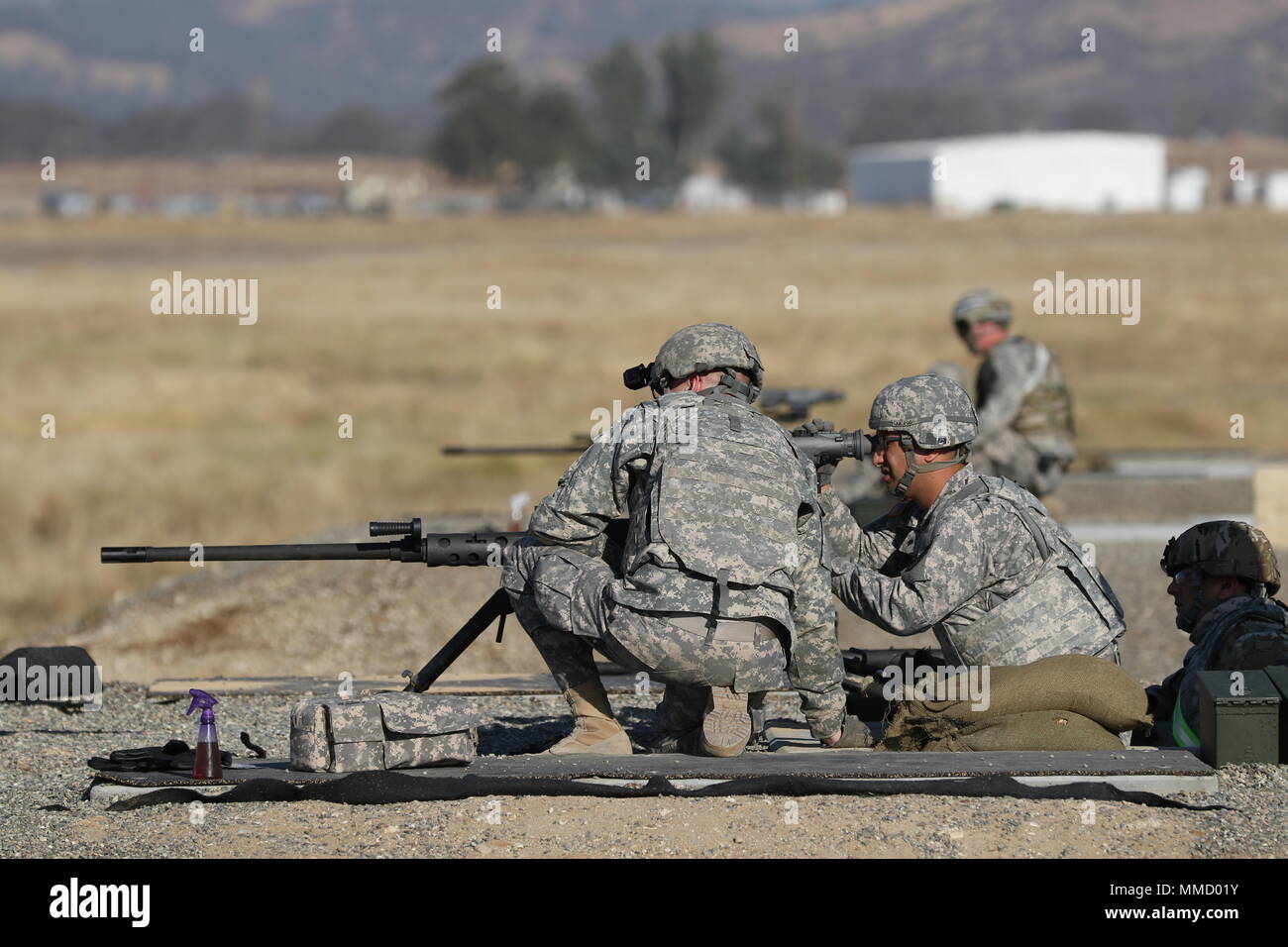 U.S. Army Reserve Soldiers with the 382nd Combat Sustainment Support Battalion, send the first rounds downrange for weapons qualifications using an M2 machine gun during Operation Cold Steel II, hosted by the 79th Theater Sustainment Command at Fort Hunter Liggett, Calif., Oct. 15, 2017. Operation Cold Steel is the U.S. Army Reserve’s crew-served weapons qualification and validation exercise to ensure that America’s Army Reserve units and Soldiers are trained and ready to deploy on short-notice and bring combat-ready and lethal firepower in support of the Army and our joint partners anywhere i Stock Photo