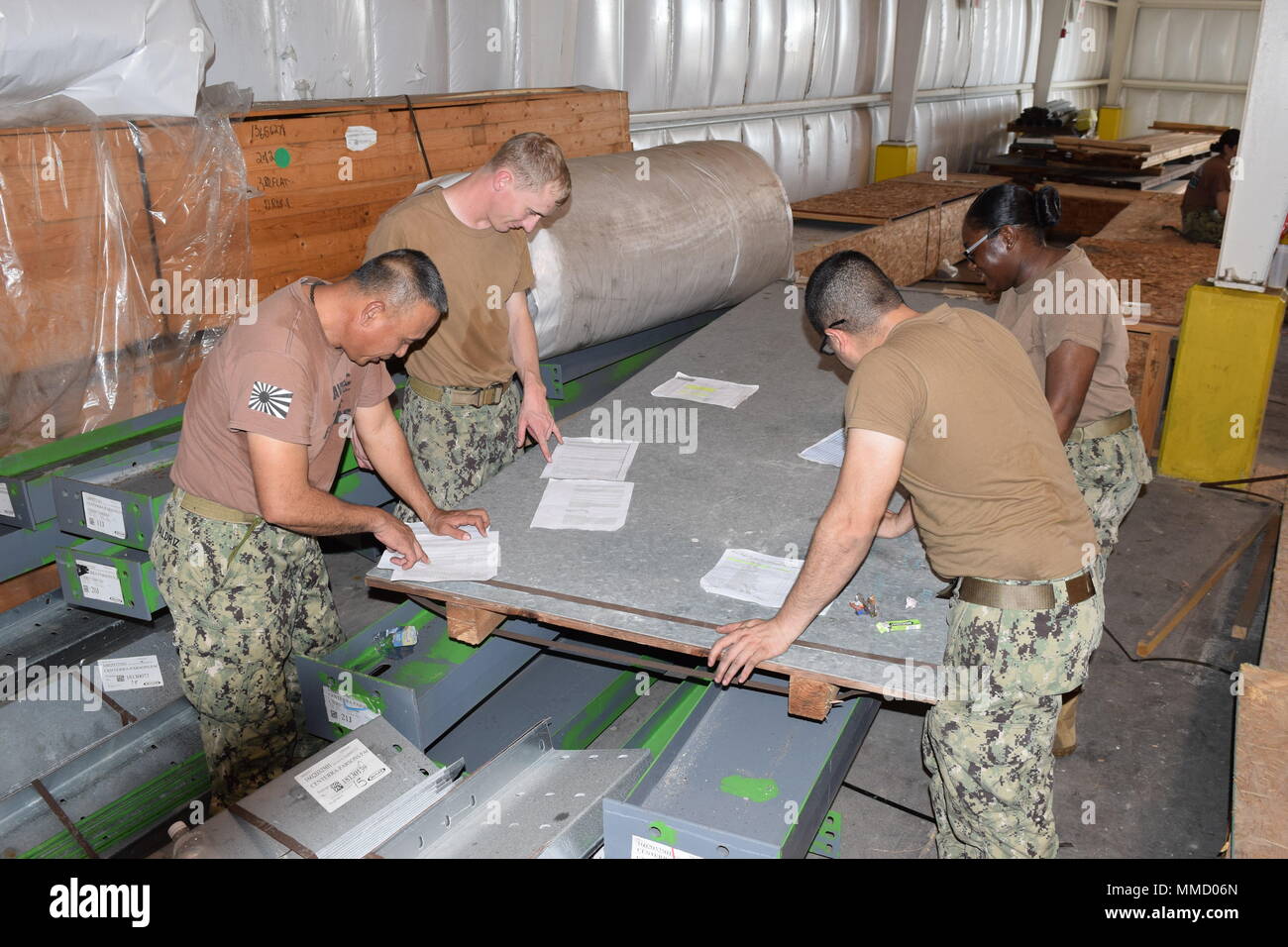 171010-N-NO181-082 DIEGO GARCIA, British Indian Ocean Territory (Oct. 10,  2017) – (Left to right) Construction Electrician 1st Class Gilbert Valdriz  from Beaumont, Calif.; Steelworker 2nd Class Joshua Schmidt from Bellmont,  NY; Equipment