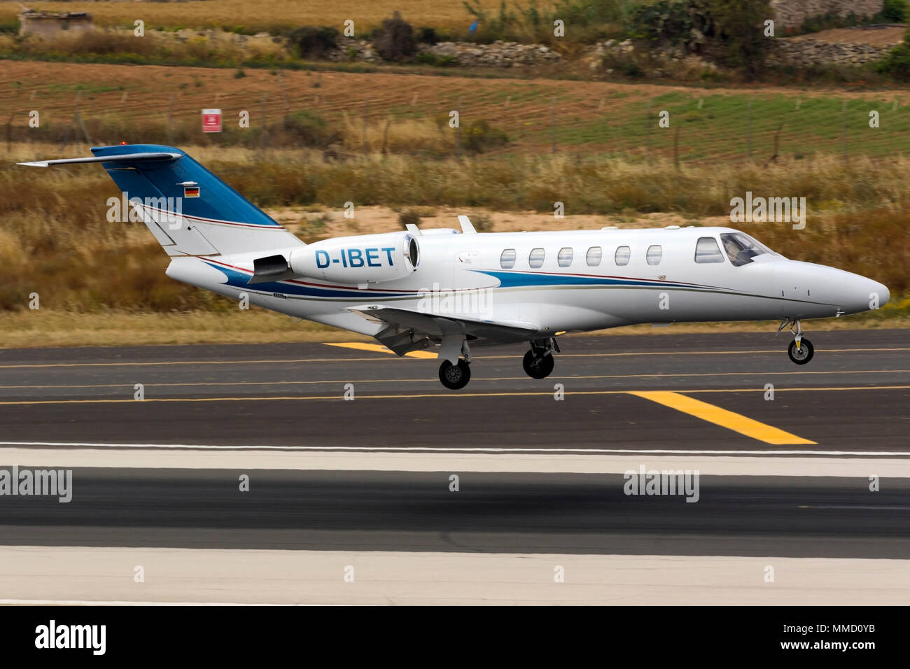 A private Cessna 525 Citation CJ2 [REG; D-IBET] performing a midfield landing runway 31. Stock Photo