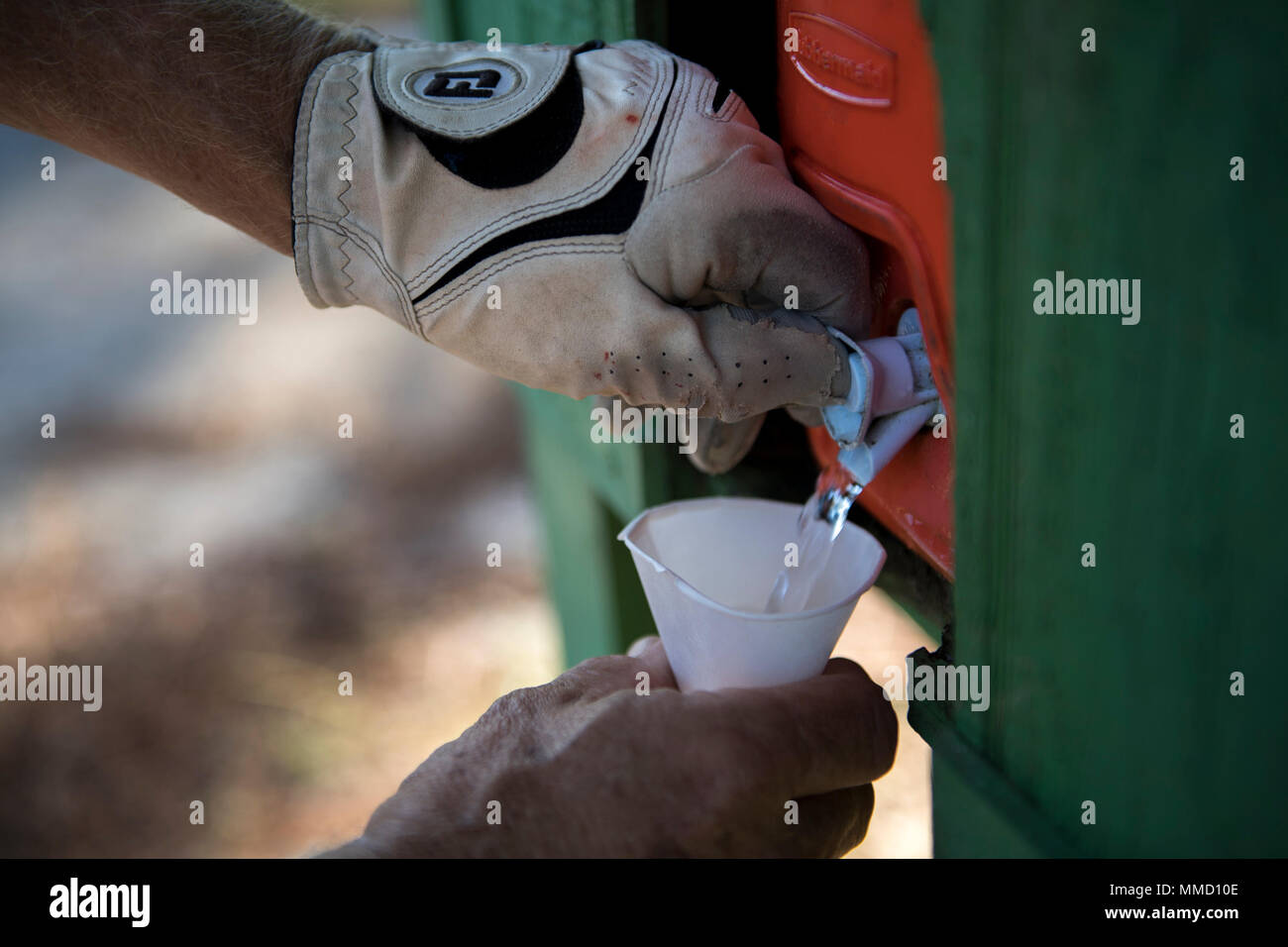 A retiree gets a cup of water during a Retiree Appreciation Week golf
