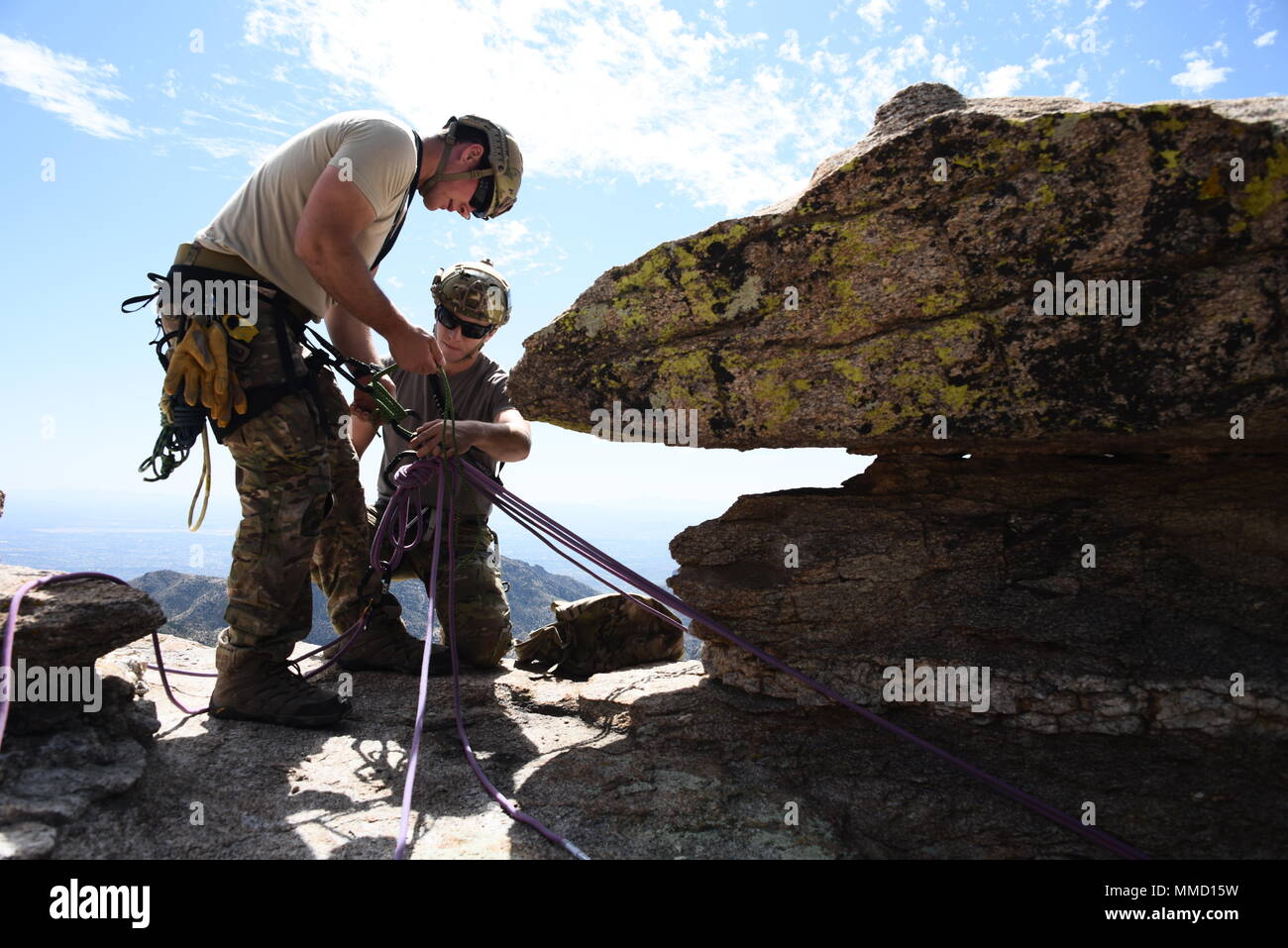 U.S. Air Force pararescuemen build a lower to rappel a rescuer during a ...