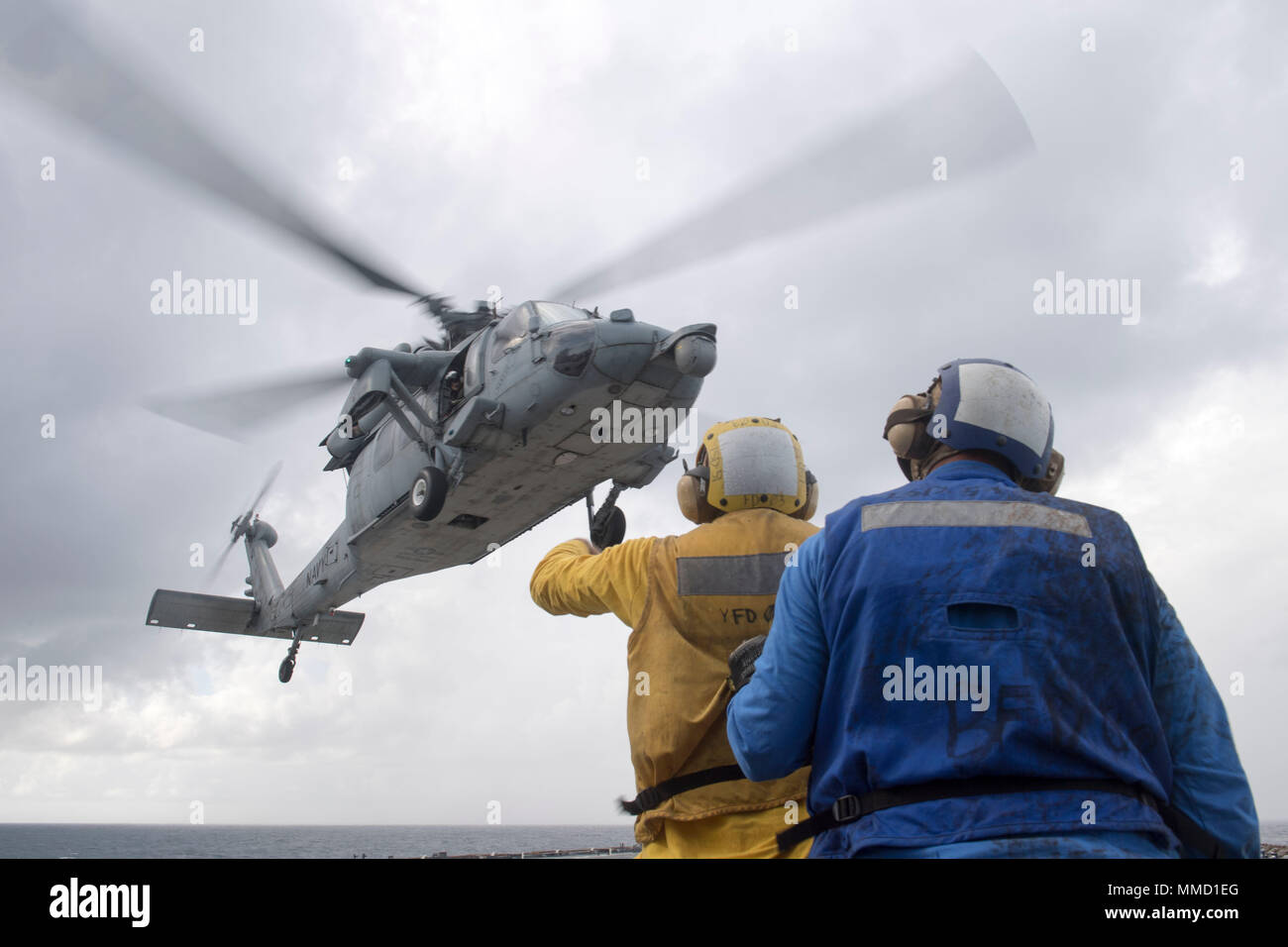 171015-N-DQ503-089 CARIBBEAN SEA (Oct. 15, 2017) Boatswain's Mate 2nd Class Jordan Johnson signals to an MH60S Seahawk helicopter as it lifts off of the flight deck of the dock landing ship USS Oak Hill (LSD 51). The Department of Defense is supporting Federal Emergency Management Agency, the lead federal agency, in helping those affected by Hurricane Maria to minimize suffering and is one component of the overall whole-of-government response effort. (U.S. Navy photo by Mass Communication Specialist 3rd Class Taylor A. Elberg) Stock Photo