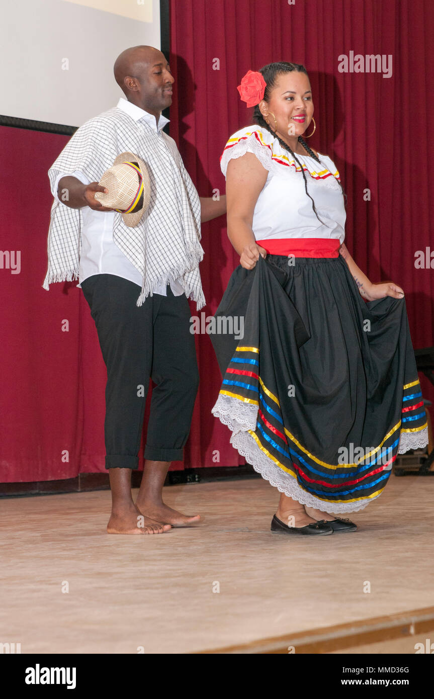 CAMP ARIFJAN, Kuwait — Staff Sgt. Rufus Fuller and Sgt. Angela Moody dance  a version of the cumbia, Oct. 13, 2017, on the Zone 1 Chapel stage as part  of a Hispanic