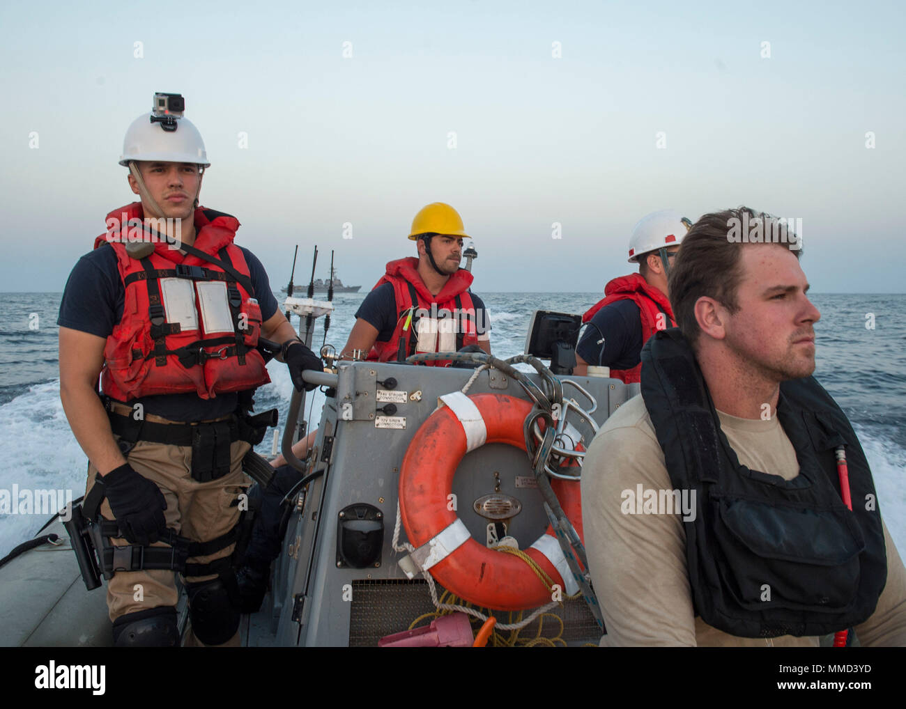 171016-N-AX638-0511   5TH FLEET AREA OF OPERATIONS (Oct. 16, 2017) Sailors assigned to the Arleigh Burke-class guided-missile destroyer USS Howard (DDG 83) transit in a rigid-hull inflatable boat en route to rescue a sea turtle entangled on a semi-sunken fishing vessel. Howard is deployed in the 5th Fleet area of operations conducting maritime security operations to reassure allies and partners, preserving freedom of navigation and maintaining the free flow of commerce. (U.S. Navy photo by Mass Communication Specialist 2nd Class Tyler Preston/Released) Stock Photo