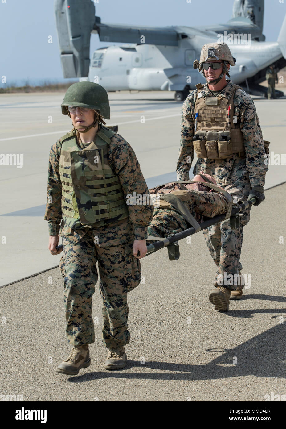U.S. Marine Corps Cpl. Kealy McMullen and Sgt. Jonathan Lambert carry a mock casualty towards medical attention on Camp Pendleton, Calif. October 18, 2017. Marines and Sailors with MAG-39, Weapons and Field Training Battalion, and 1st Medical Battalion conducted a Combat Operational Medical Emergency Transport Training exercise to prepare for future deployments. (U.S. Marines Corps photo by Pfc. Dalton S. Swanbeck) Stock Photo