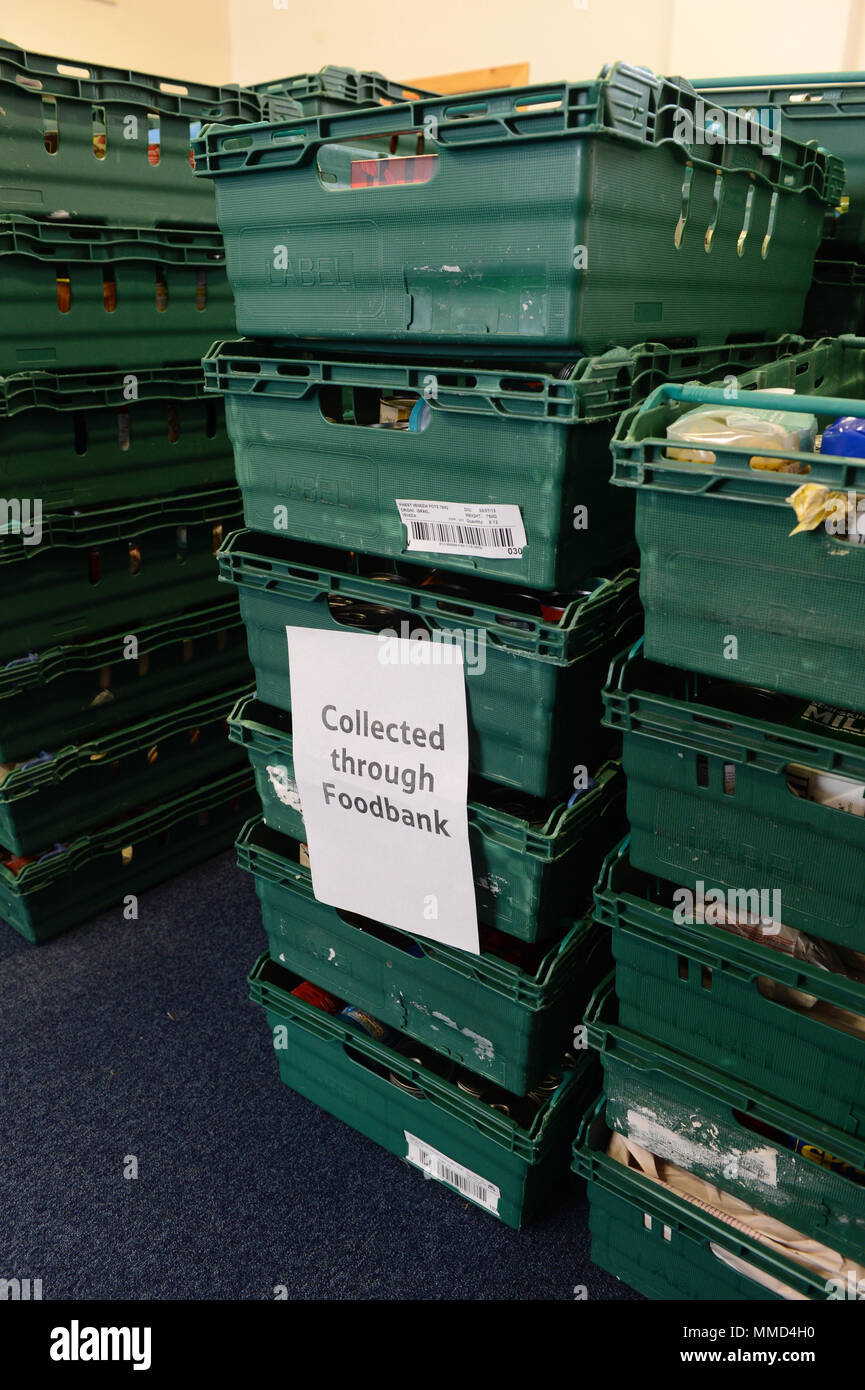 Boxes of food piled up in a food bank for distribution to people in need Stock Photo