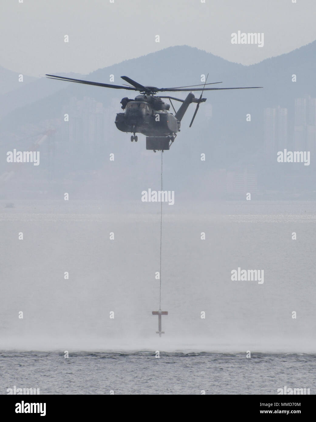 171019-N-TB148-305 BUSAN, Republic of Korea (Oct. 19, 2017) A MH-53E Sea Dragon assigned to the Vanguards of Helicopter Mine Countermeasures Squadron (HM) 14, Detachment 2A lowers a sonar buoy designed to detect underwater mines during the annual Multinational Mine Warfare Exercise (MN MIWEX). MN MIWEX is a mine countermeasures exercise between the U.S., Republic of Korea, and U.N. Command Sending States meant to increase combined capabilities and readiness to respond to any contingency on the Korean peninsula. (U.S. Navy photo by Mass Communication Specialist Seaman William Carlisle) Stock Photo