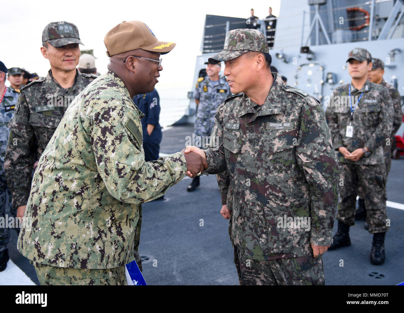 171019-N-TB148-582 BUSAN, Republic of Korea (Oct. 19, 2017) Capt. Glen Leverette, deputy commander, U.S. Naval Forces Korea (CNFK) shakes hands with Republic of Korea (ROK) navy Rear Adm. Kim, Jong Sam, commander, ROK Flotilla 5, aboard the ROKS Cheong Wang Bong (LST 686) during the annual Multinational Mine Warfare Exercise (MN MIWEX). MN MIWEX is a mine countermeasures exercise between the U.S., Republic of Korea, and U.N. Command Sending States meant to increase combined capabilities and readiness to respond to any contingency on the Korean peninsula. (U.S. Navy photo by Mass Communication  Stock Photo