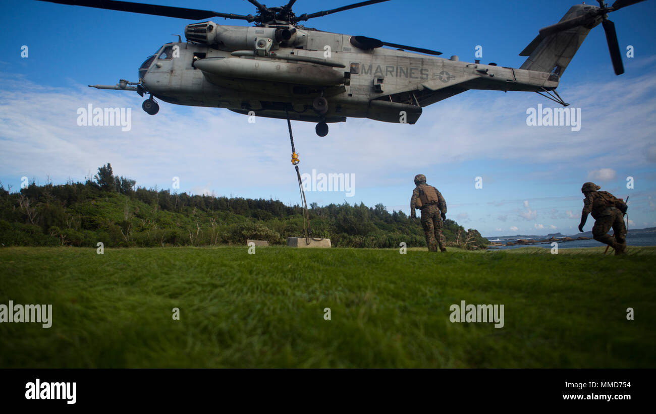 A CH-53E Super Stallion lifts a cement block during an external lift drill with Marines from Combat Logistics Battalion 31 at Kin Blue Training Area, Camp Hansen, Okinawa, Japan, Oct. 19, 2017. CLB-31, the Logistics Combat Element of the 31st Marine Expeditionary Unit, provides logistic support to all elements of the MEU.   As the Marine Corps’ only continuously forward-deployed unit, the 31st MEU air-ground-logistics team provides a flexible force, ready to perform a wide range of military operations, from limited combat to humanitarian assistance operations, throughout the Indo-Asia-Pacific  Stock Photo