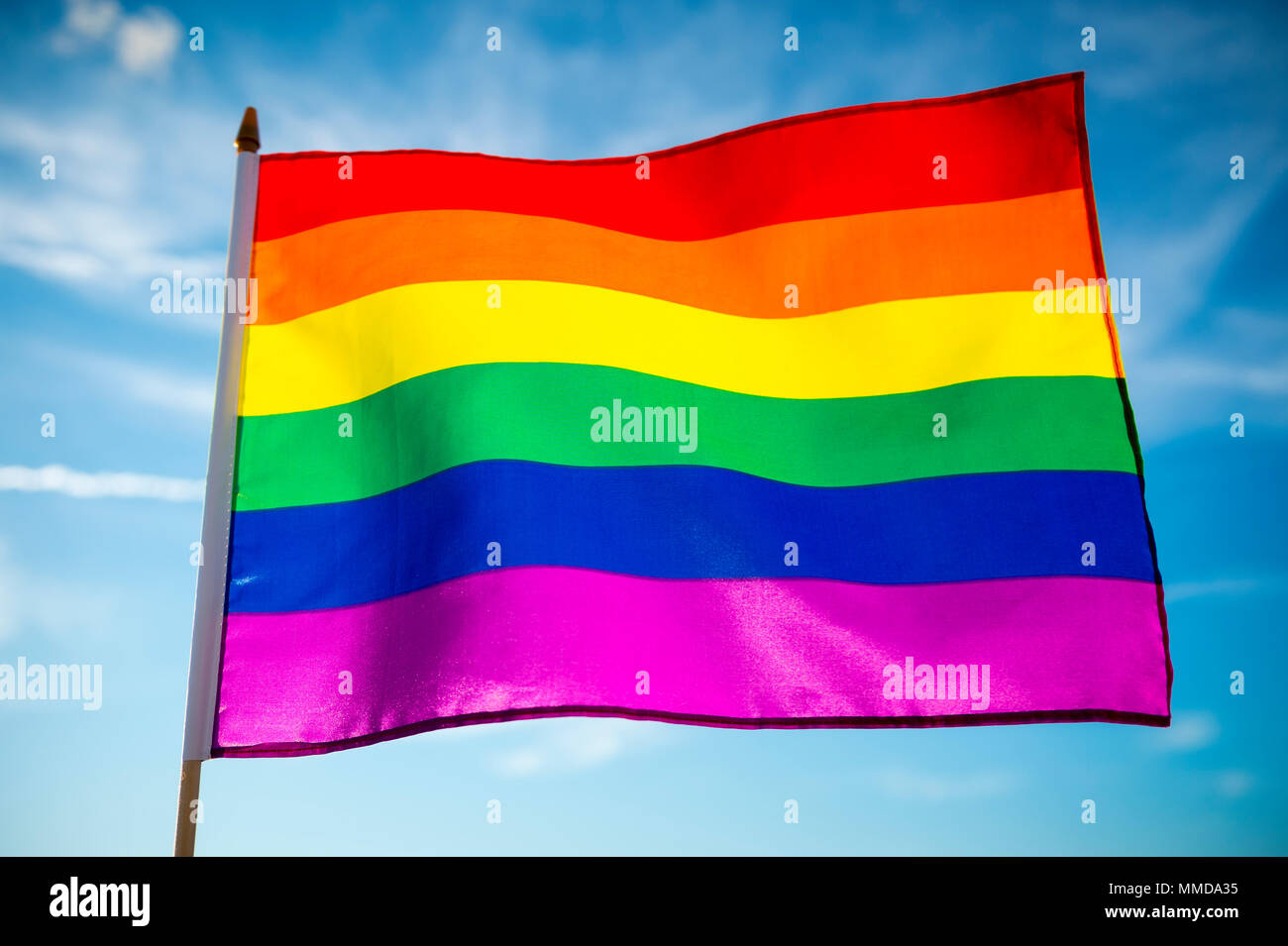 Gay pride rainbow flag flutters in the breeze Stock Photo - Alamy