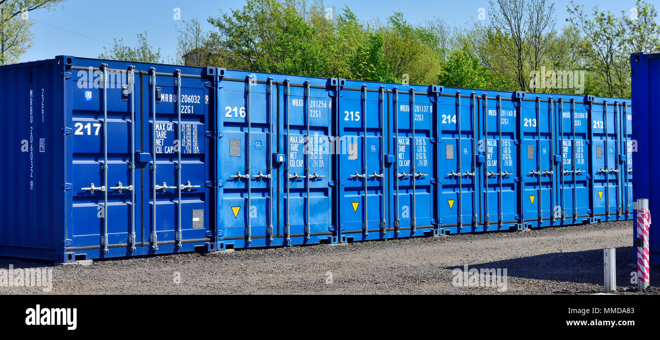Blue painted steel shipping containers used for storage Stock Photo Alamy