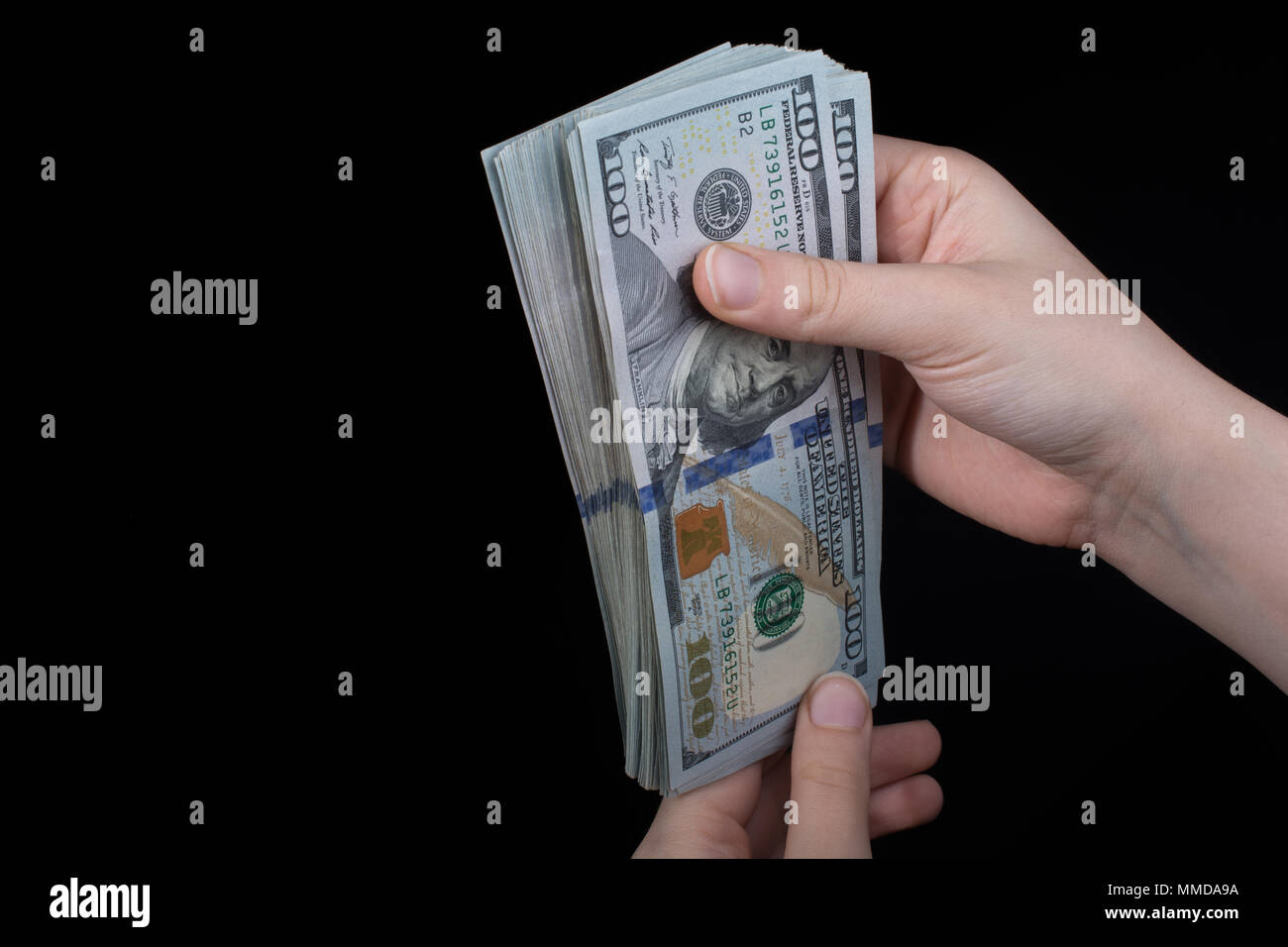 Hand holding American dollar banknotes isolated on white background ...