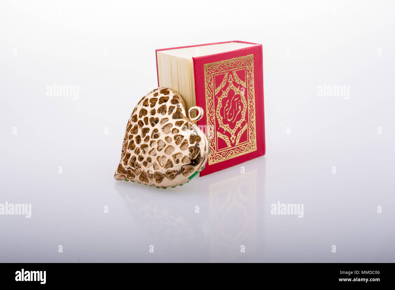 Heart shape and Islamic Holy Book Quran mini size Stock Photo - Alamy