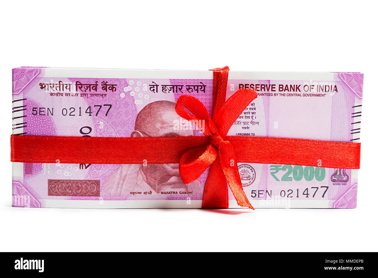 Bundle of Hundred And Two-Thousand Rupee notes wrapped money with ribbon Stock Photo