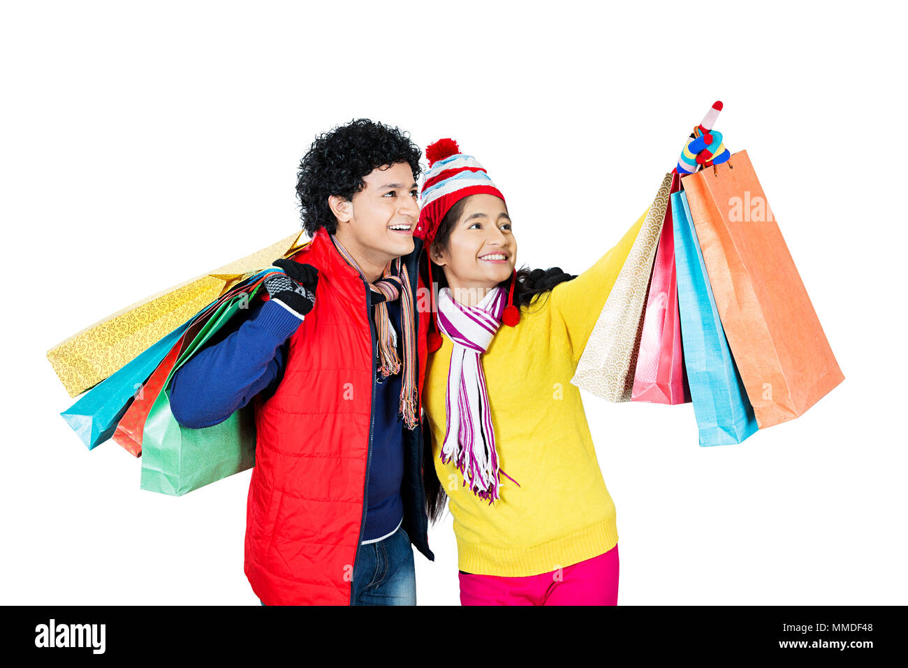 Two Teenager Friend In-Winter Clothes Shopping Bags Pointing Finger Something Stock Photo