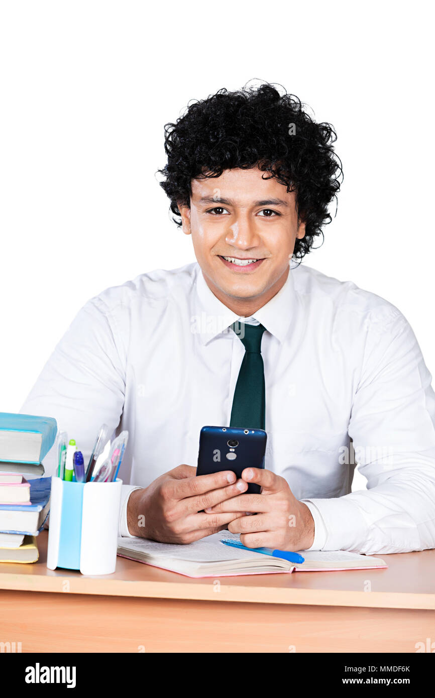 One High School Boy Student Sitting In-Classroom Reading Text-Message Cellphone Stock Photo