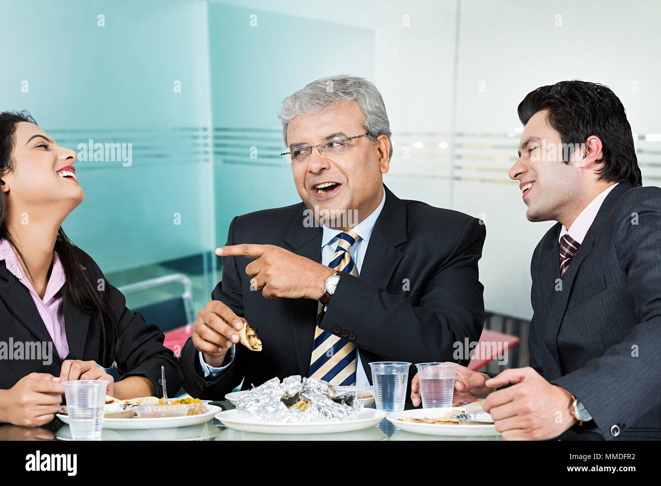 Three businesswoman and businessmen eating lunch in Break-time office cafeteria Stock Photo