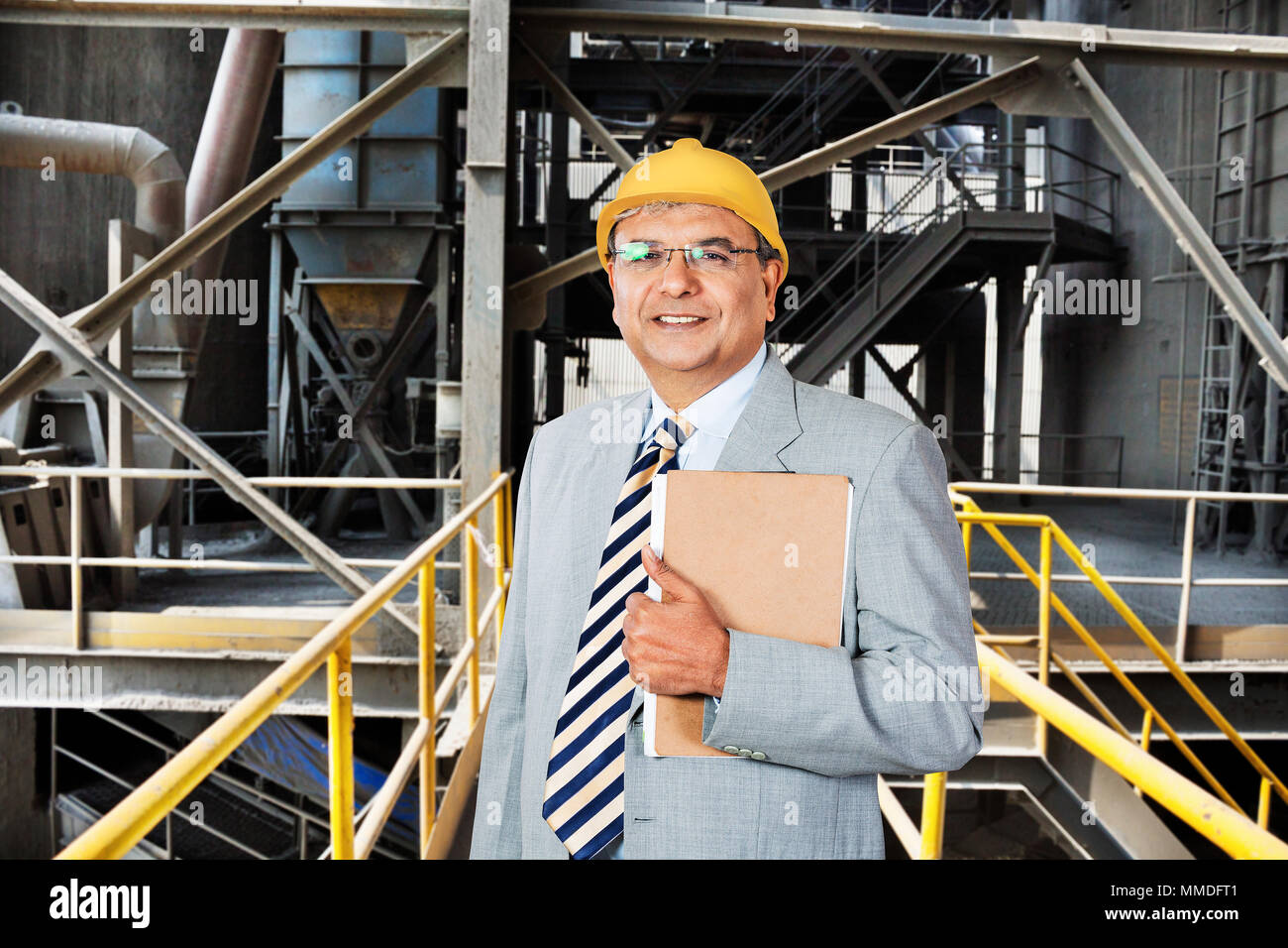 Portrait of Male Factory supervisor Holding Clipboard Machinery in Factory-industry Stock Photo