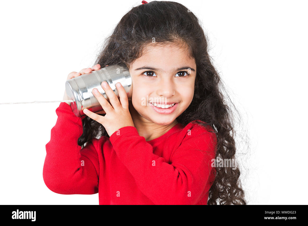 One Little Girl listening tin-can phone connected by string, concept for communication Stock Photo
