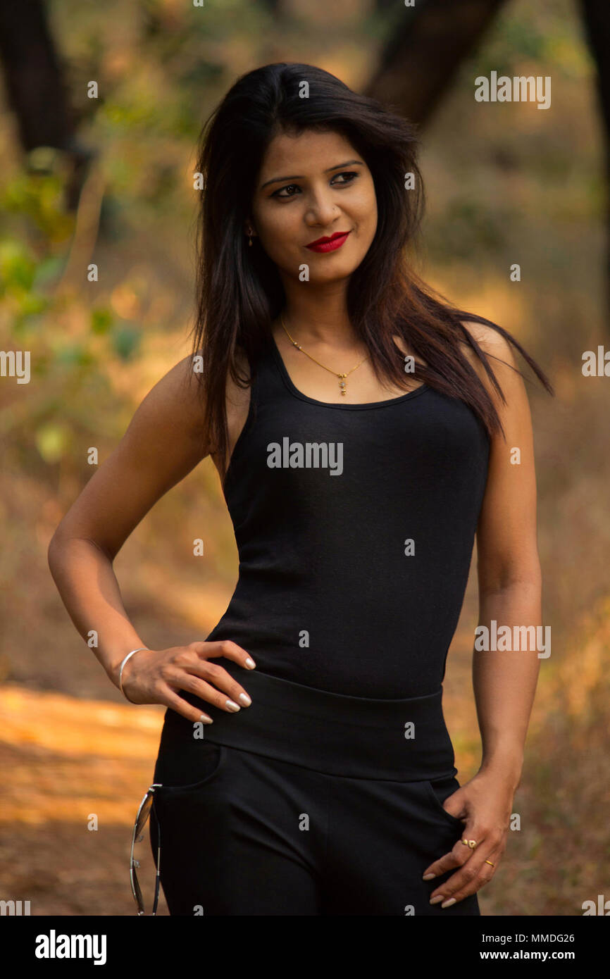 Stylish woman wearing black top and leggings smiling Stock Photo Alamy