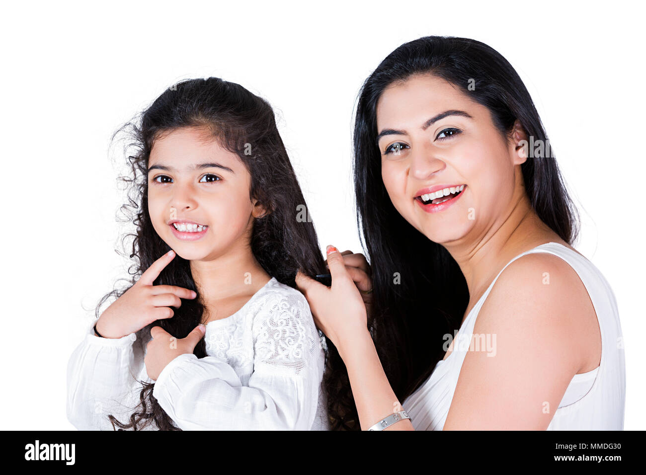 Mother is caring her lovely Kid daughter hair combing Hair-Care Stock Photo