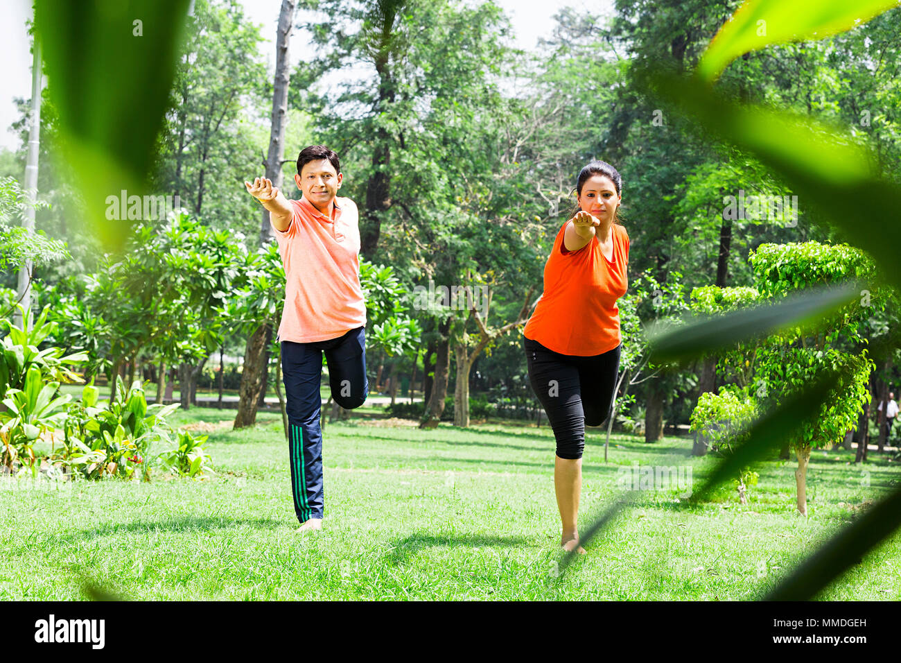 Two Couple Doing Yoga Dandayamana Dhanurasana Stretching Fitness Exercise Garden Stock Photo Alamy