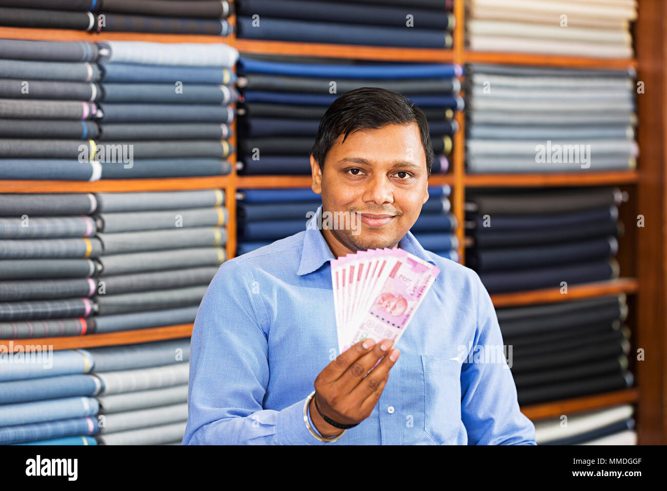 One Sales Man Showing Indian Two-Thousand Rupees Banknote Clothes Market Stock Photo