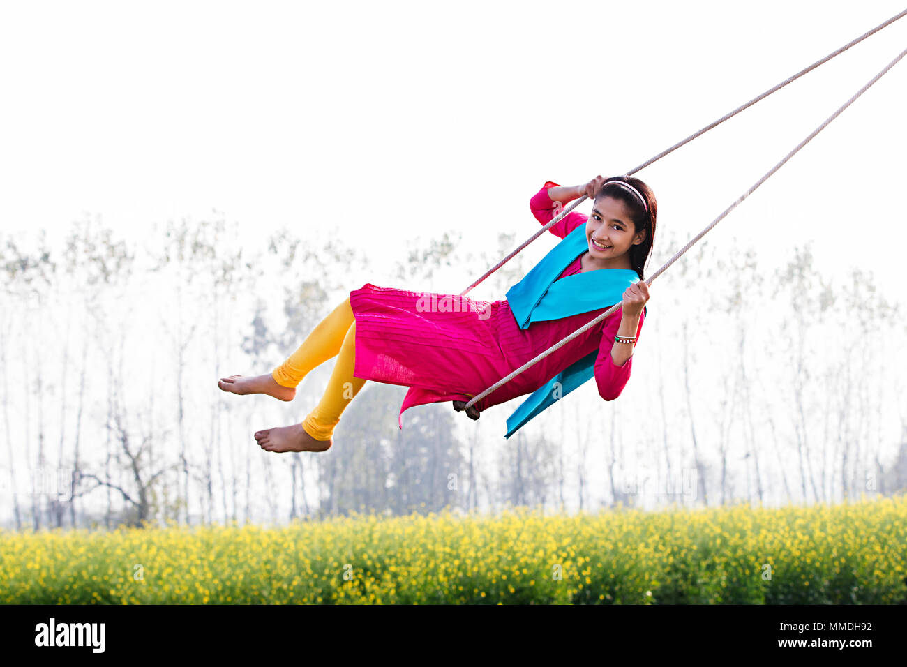 Happy Indian Rural Teenage Girl Playing Swing Spring Ropes Field Stock