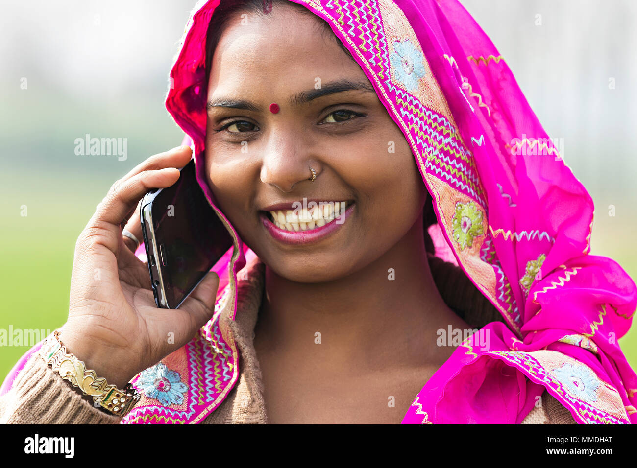 One Indian Rural Villager Female Talking On Mobile-Phone Outdoors Village Stock Photo