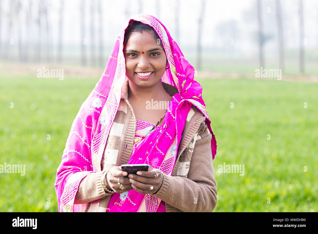 One Rural Villager Female ReadingText-Message Mobile Phone Field Village Stock Photo