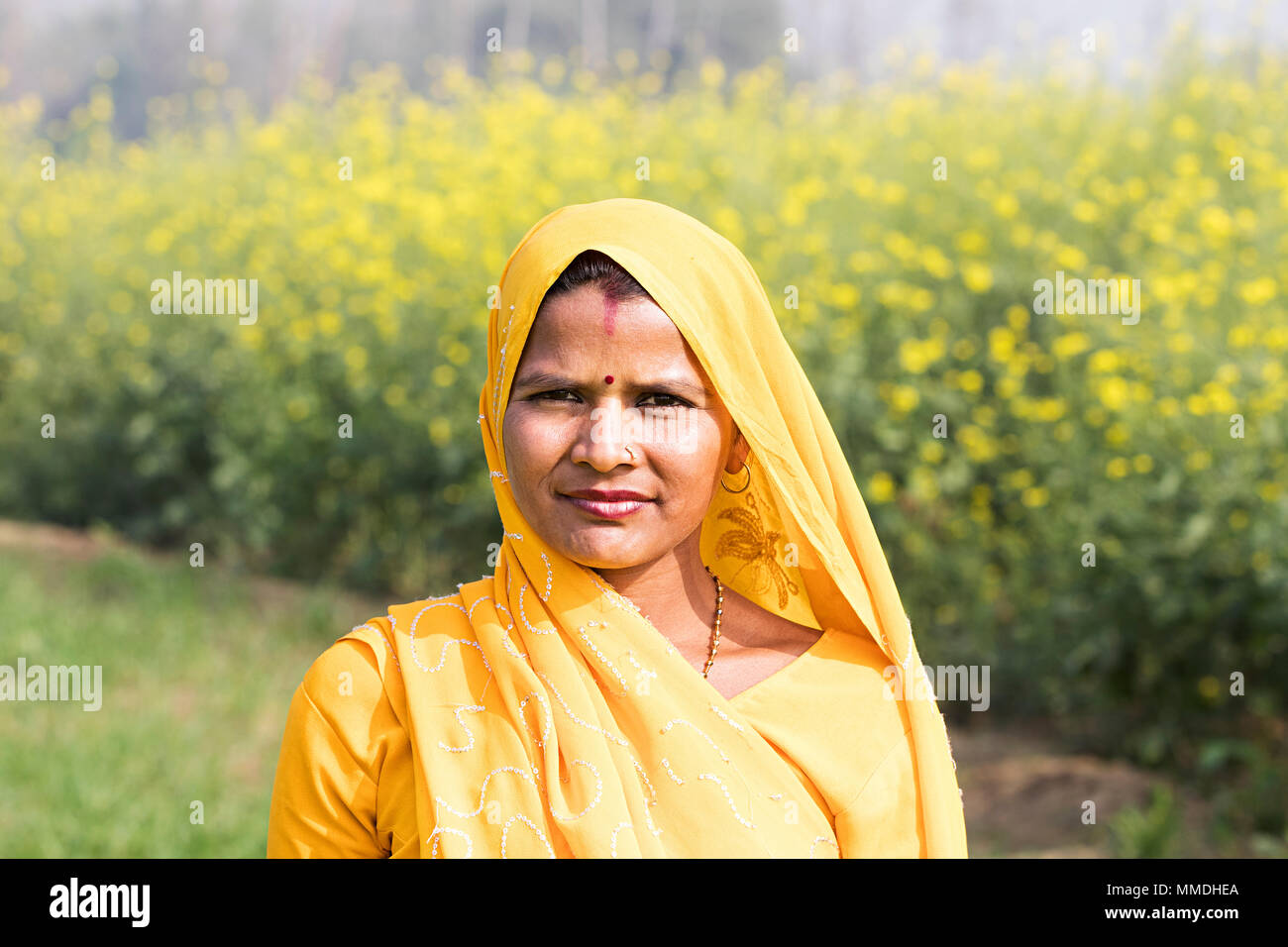 One Indian Rural Farmer Female Housewife Standing In-Farm Village Stock Photo