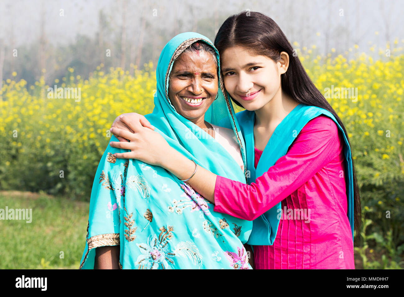 Happy Rural Villager Mother And Teenage Daughter Together In-Farm Village Stock Photo