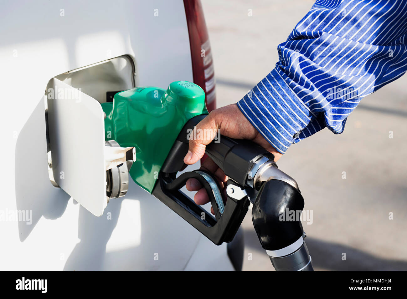 male Employees controlled the fuel pump with Fuel Nozzles Adding