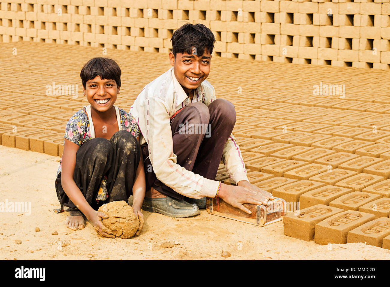 Two Boy,Girl Workers to make Bricks In brick-factory Village Stock Photo