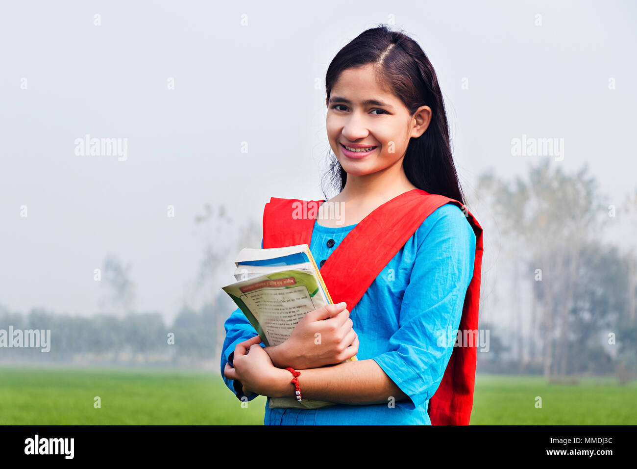 Rural Young Girl College Student Holding Books Education In-Farm Outdoors Stock Photo