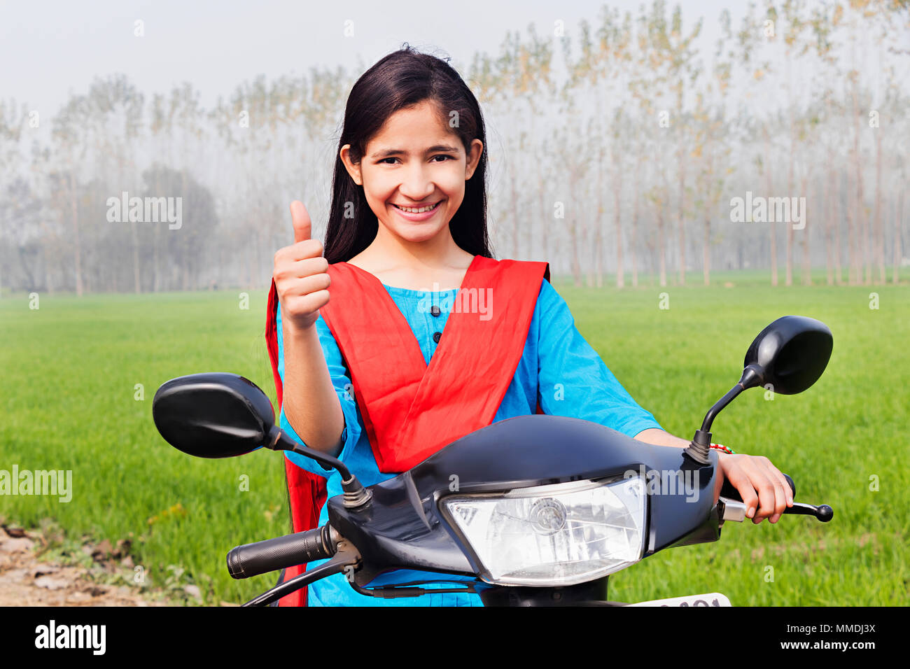 Rural Young Girl Sitting Scooter And Showing Thumbs-up Farm Village Stock Photo