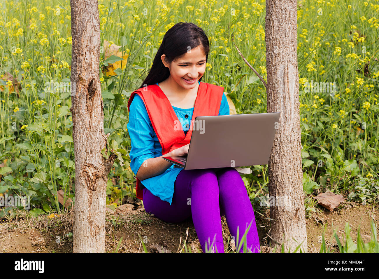 Rural Villager College Girl Student Sitting In-Farm, Laptop Working E-Learning Stock Photo