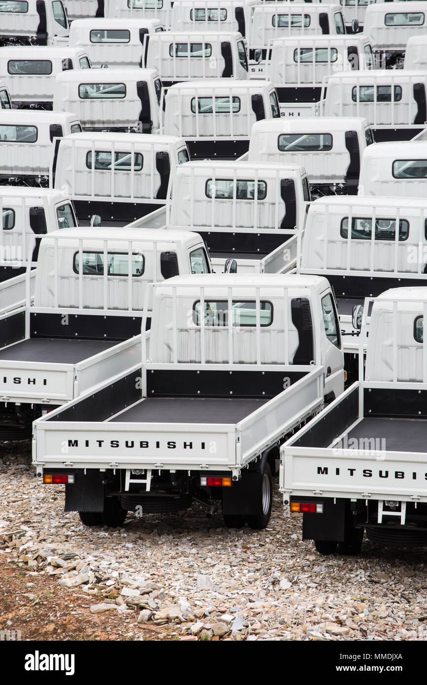 Vertical view of a row of white trucks. Stock Photo